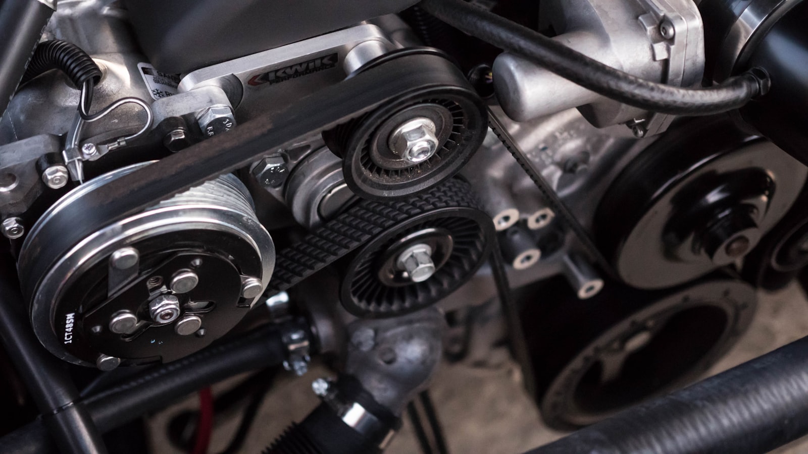 Close-up of engine belts and pulleys during an inspection