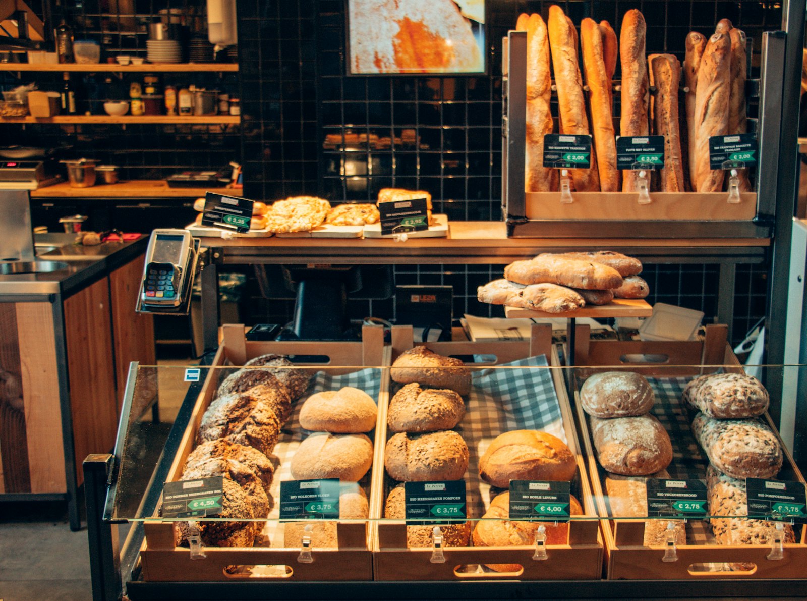 Bakery display filled with fresh loaves, baguettes, and pastries