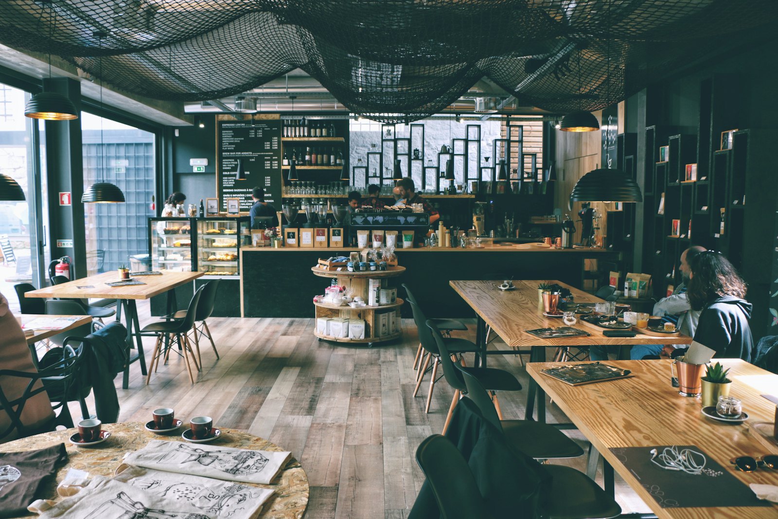 Long wooden tables and the brew bar inside the cafe