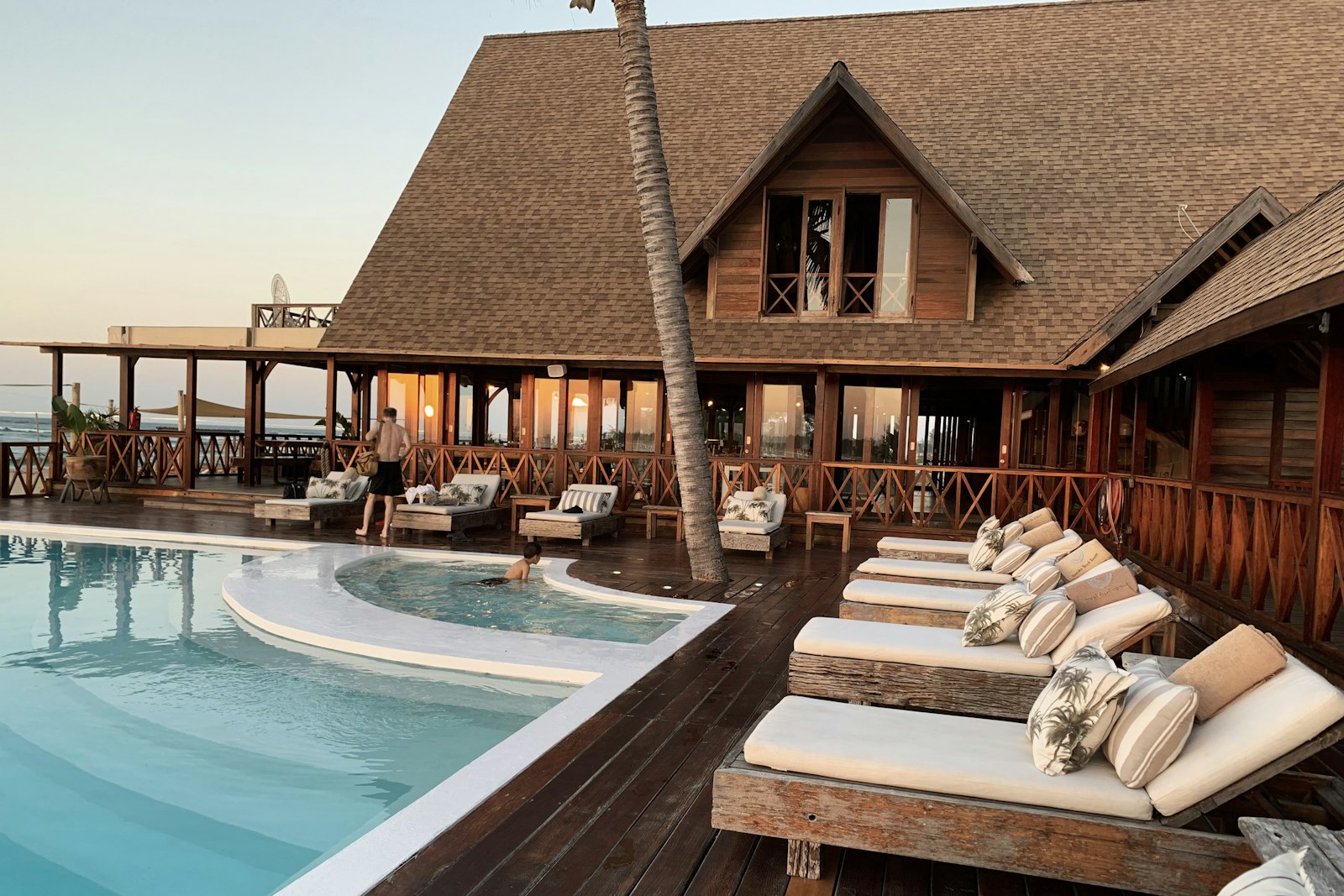 Sunset over The Amaya's timber pavilions, pool deck and daybeds