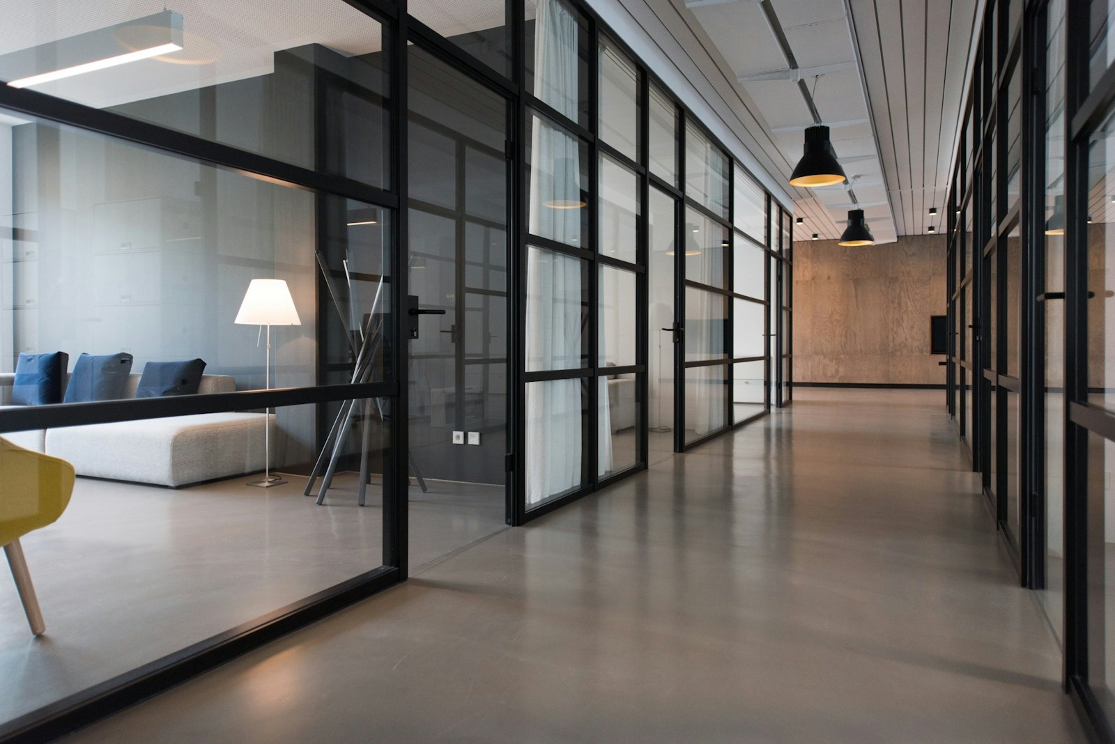 Modern glass-partitioned office corridor at the firm's chambers